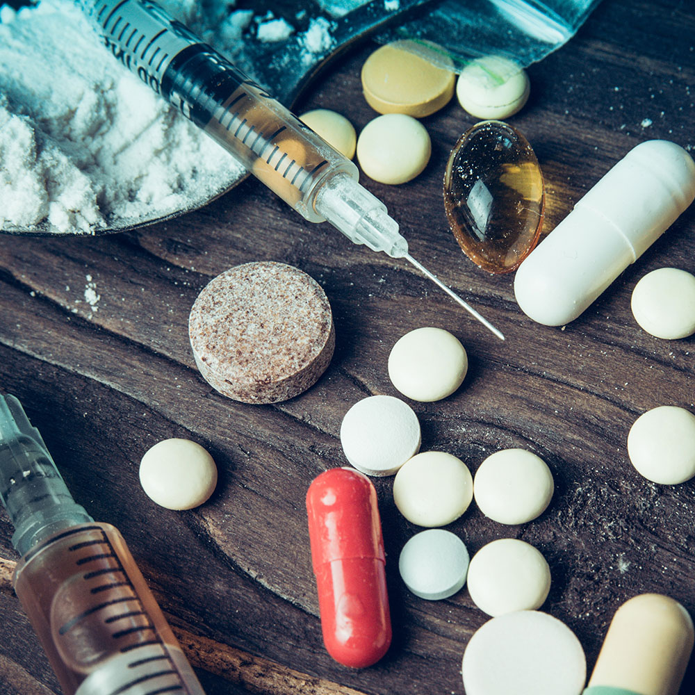 Illicit drugs, pills, powder and syringe